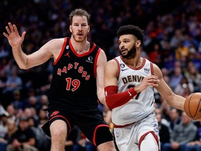 Nuggets guard Jamal Murray (right) controls the ball ahead of Raptors centre Jakob Poeltl (left) during second quarter NBA action at Ball Arena in Denver, Monday, March 6, 2023.