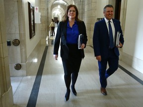 Premier Heather Stefanson (left) and Finance Minister Cliff Cullen on their way to present the 2023 provincial budget at the Manitoba Legislative Building in Winnipeg on Tues., March 7, 2023.