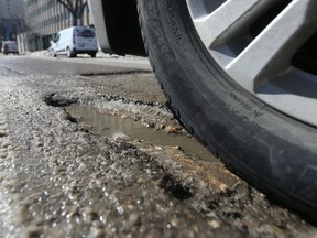 A pot hole on a road in Winnipeg on Friday, March 31, 2023.