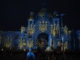 The train station in Lviv, Ukraine, is lit up by Swiss artist Gerry Hofstetter, on Feb. 22, 2023. Ukrainian officials in Lviv say there's another way Canadians can support the embattled country's economy and war effort, but it's not for the faint of heart: pack your bags and come be a tourist.