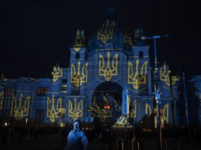 The train station in Lviv, Ukraine, is lit up by Swiss artist Gerry Hofstetter, on Feb. 22, 2023. Ukrainian officials in Lviv say there's another way Canadians can support the embattled country's economy and war effort, but it's not for the faint of heart: pack your bags and come be a tourist.
