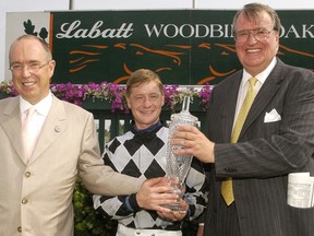(Left to right) Gold Strike's Trainer Reade Baker, Jockey Jim McAleney and owner Harlequin Ranches's Richard Bonnycastle after winning the 2005 Woodbine Oaks.