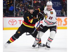 Vancouver Canucks defenceman Luke Schenn (2) defends against Chicago Blackhawks forward Jonathan Toews (19) during the first period at Rogers Arena in Vancouver on Jan. 24, 2023.
