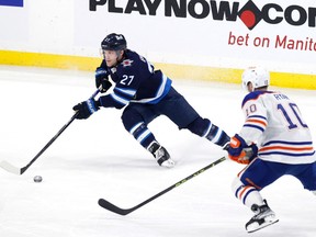 Winnipeg Jets left wing Nikolaj Ehlers (27) skates past Edmonton Oilers center Derek Ryan (10) in the third period at Canada Life Centre in Winnipeg on Saturday, March 4, 2023.