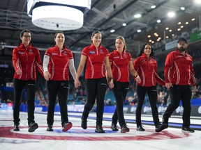 Team Canada skip Kerri Einarson, from left to right, third Val Sweeting, second Shannon Birchard, lead Briane Harris, alternate Krysten Karwacki and coach Reid Carruthers walk down the ice after defeating Manitoba in the final at the Scotties Tournament of Hearts, in Kamloops, B.C., on Sunday, February 26, 2023. Einarson's quest to complete unfinished business at the women's world curling championship starts Saturday.