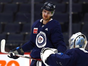 Mark Scheifele talks to goaltender David Rittich during Winnipeg Jets practice on Wednesday, Feb. 15, 2023.