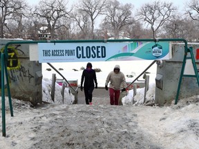 People exit the Nestaweya River Trail at the Hugo Docks in Winnipeg on Sunday, March 5, 2023. The Forks announced the closure of the trail from the Hugo Docks to the Donald Street Bridge along the Assiniboine River.