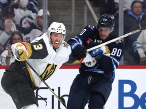 Pierre-Luc Dubois of the Jets battles with Brayden McNabb of the Golden Knights during Game 3 of the Stanley Cup playoff series between the two teams at Canada Life Centre on Saturday.