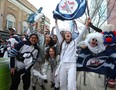 Fans dressed in white celebrate outside Canada Life Centre on Monday during Game 4 of a playoff series against the Vegas Golden Knights.