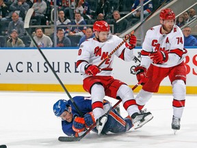 Sebastian Aho (20) of the Carolina Hurricanes checks Mathew Barzal (13) of the New York Islanders during the second period in Game 6 of the First Round of the 2023 Stanley Cup Playoffs at UBS Arena on April 28, 2023 in Elmont, N.Y.