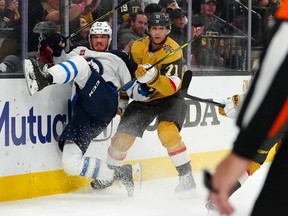 Dylan Samberg of the Jets gets taken down by Golden Knights centre William Karlsson during Game 2 on Thursday night.
