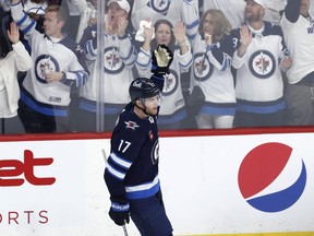Adam Lowry celebrates his goal with 22 seconds left that sent Game 3 into overtime, capping a three-goal comeback by the Jets.