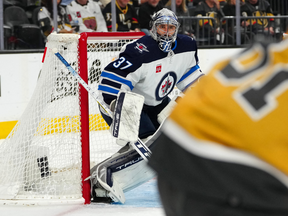 Apr 18, 2023; Las Vegas, Nevada, USA; Winnipeg Jets goaltender Connor Hellebuyck (37) watches Vegas Golden Knights right wing Jonathan Marchessault (81) during the second period of game one of the first round of the 2023 Stanley Cup Playoffs at T-Mobile Arena. Mandatory Credit: Stephen R. Sylvanie-USA TODAY Sports