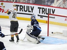 Ivan Barbashev (49) of the Vegas Golden Knights celebrates after a shot from teammate Michael Amadio beat Connor Hellebuyck (37) of the Winnipeg Jets in the second overtime period of Game 3 in Winnipeg on Saturday night.