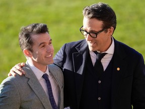 Co-Owners Wrexham AFC Rob McElhenney and Ryan Reynolds talk as they wait for the arrival of King Charles III and Camilla, Queen Consort for their visit to Wrexham AFC on December 09, 2022 in Wrexham, Wales.