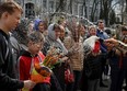 An Orthodox priest sprays holy water on believers after a service which marks the Orthodox feast of Palm Sunday, amid Russia's invasion of Ukraine, in Kyiv, Ukraine April 9, 2023.