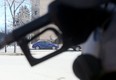 A car seen through the handle of a gas pump