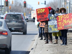 People protesting what they call the failed policies of Royal Bank of Canada undermining indigenous sovereignty and fuelling climate crisis, near an RBC branch in Winnipeg on Saturday, April 1, 2023.