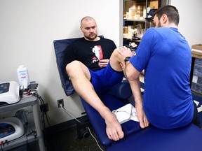Winnipeg Blue Bombers defensive end Thiadric Hansen works with strength and conditioning co-ordinator Brayden Miller at the Blue Bombers facility on Tuesday, April 4. He is working his way back from a ruptured Achilles tendon.