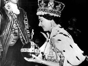 Queen Elizabeth II wears the bejewelled Imperial Crown and carries the orb and scepter as she leaves Westminster Abbey on June 2, 1953 at the end of the Coronation Ceremony.