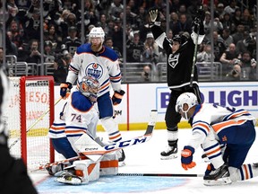 Apr 21, 2023; Los Angeles, California, USA; Los Angeles Kings left wing Trevor Moore (12) celebrates after scoring the winning goal as Edmonton Oilers defenseman Mattias Ekholm (14), defenseman Darnell Nurse (25) and goaltender Stuart Skinner (74) look on in the first overtime period of game three of the first round of the 2023 Stanley Cup Playoffs at Crypto.com Arena.