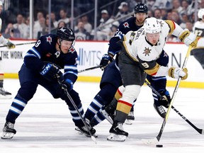 Apr 22, 2023; Winnipeg, Manitoba, CAN; Vegas Golden Knights center Jack Eichel (9) is checked by Winnipeg Jets right wing Saku Maenalanen (8) in the first period in game three of the first round of the 2023 Stanley Cup Playoffs at Canada Life Centre. Mandatory Credit: James Carey Lauder-USA TODAY Sports