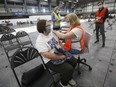 Manitoba's auditor general says the province's COVID-19 vaccine rollout was effective but there is room for improvement. Nora Valencia receives her vaccination at Manitoba's COVID-19 vaccination centre in a soccer complex in north Winnipeg, Friday, May 7, 2021.