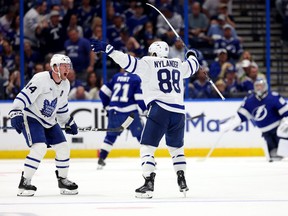 Morgan Rielly #44 and William Nylander #88 of the Toronto Maple Leafs celebrate an overtime goal by Ryan O'Reilly of the Toronto Maple Leafs during Game 3 in Tampa last night.