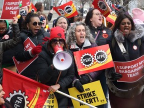 Members of the Public Service Alliance of Canada (PSAC) demonstrate outside the Treasury Board building in Ottawa on Friday, March 31, 2023. The union that represents over 120,000 public servants has voted in favour of a national strike mandate.