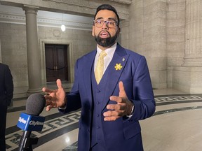 Obby Khan speaks to reporters after being sworn-in as a member of the Manitoba legislature in Winnipeg, Monday, April 4, 2022. A Manitoba cabinet minister is accusing Opposition NDP Leader Wab Kinew of swearing at him and shoving him.