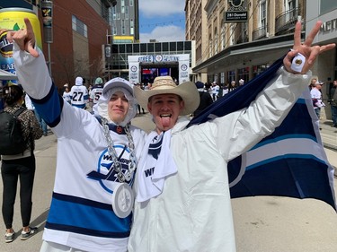 Richard Vanduwater (right) and Brandon Stuart celebrate during the Winnipeg Whiteout Street Party on Saturday, April 22, 2023, outside Canada Life Centre in Winnipeg ahead of the start of Game 3 of the Jets-Vegas Golden Knights NHL playoff series.