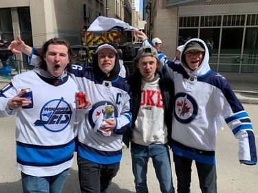 Tristan Roman (left), Connor Matuszewski (second from right) and their buddies celebrate at the Winnipeg Whiteout Street Party on Saturday, April 22, 2023, outside Canada Life Centre in Winnipeg ahead of the start of Game 3 of the Jets-Vegas Golden Knights NHL playoff series.