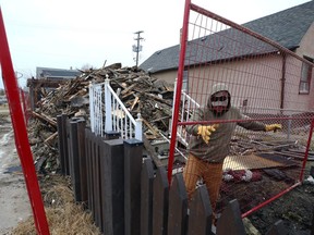 Fencing is installed around the perimeter of a two-storey home on Logan Avenue in Winnipeg which was demolished after an early-morning fire on Wednesday, April 26, 2023. A man died in the home during a fire in November 2022.