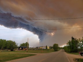 Wildfire crews are working to suppress a fire near a northern Manitoba First Nation that has forced some residents to leave the community.