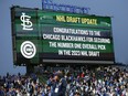 The video board at Wrigley Field announces the Chicago Blackhawks won the NHL Draft Lottery during the game between the Chicago Cubs and the St. Louis Cardinals.