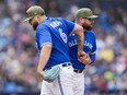 Blue Jays manager John Schneider sheepishly takes the ball from starter Alek Manoah in the sixth inning at the Rogers Centre on May 20, 2023.