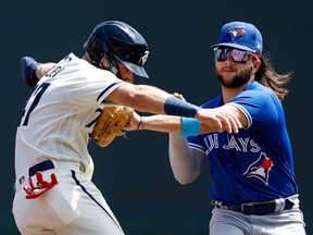 Bo Bichette of the Toronto Blue Jays tags out Edouard Julien of the Minnesota Twins in the first inning at Target Field on May 28, 2023, in Minneapolis, Minn.