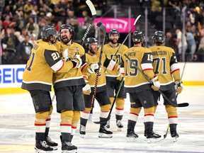 Brett Howden, left, of the Vegas Golden Knights is congratulated by Mark Stone, second from left, after scoring the game-winning goal against the Dallas Stars during overtime in Game 1 of the Western Conference Final of the 2023 Stanley Cup Playoffs at T-Mobile Arena on May 19, 2023 in Las Vegas, Nevada.
