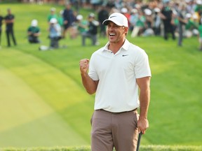 Brooks Koepka of the United States celebrates winning on the 18th green during the final round of the 2023 PGA Championship at Oak Hill Country Club on May 21, 2023 in Rochester, N.Y.