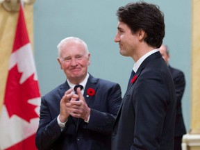 Governor General David Johnston applauds as he presents Prime Minister Justin Trudeau following his swearing-in during a ceremony at Rideau Hall in 2015.