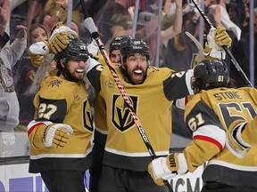 Chandler Stephenson, centre, of the Vegas Golden Knights celebrates his game winning overtime goal against the Dallas Stars with teammates in Game 2 of the Western Conference Final of the 2023 Stanley Cup Playoffs at T-Mobile Arena on May 21, 2023 in Las Vegas, Nevada.