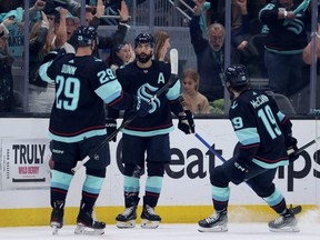Kraken forward Jordan Eberle, centre, celebrates his goal with teammates Vince Dunn, left, and Jared McCann, right, against the Stars during the first period in Game 6 of the second round of the 2023 Stanley Cup Playoffs at Climate Pledge Arena in Seattle, Saturday, May 13, 2023.