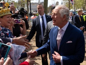 King Charles III greets well-wishers on The Mall ahead of his coronation, in London, England, Friday, May 5, 2023.