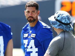 Punting hopeful Karl Schmitz talks with special teams coach Paul Boudreau during Winnipeg Blue Bombers rookie camp on Wednesday at IG Field.