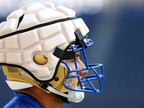 Winnipeg Blue Bombers defensive end Anthony Bennett wears a Guardian Cap over his helmet during a training camp session on Wednesday.