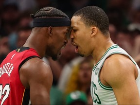 Jimmy Butler, left, of the Miami Heat exchanges words with Grant Williams of the Boston Celtics during the fourth quarter in Game 2 of the Eastern Conference Finals at TD Garden on May 19, 2023 in Boston.
