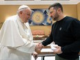 This photo taken and issued as a handout on May 13, 2023 by the Vatican Media shows Pope Francis shake hands with Ukrainian President Volodymyr Zelenskyy following a private audience in The Vatican.
