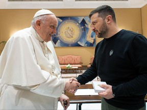 This photo taken and issued as a handout on May 13, 2023 by the Vatican Media shows Pope Francis shake hands with Ukrainian President Volodymyr Zelenskyy following a private audience in The Vatican.