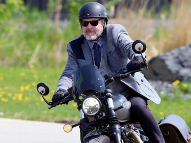 A participant in the Winnipeg version of the Distinguished Gentlemen's Ride exit motorcycle shop Moto 49 in St. Boniface en route to Torque Brewing on King Edward Street in support of men's health charity Movember on Sunday, May 21, 2023.