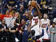 Jimmy Butlerof the Miami Heat shoots over Kentavious Caldwell-Pope of the Denver Nuggets during the NBA Finals.